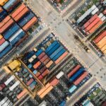 Aerial view of a stacked shipping container yard representing hidden tier 2 supplier visibility risk in the supply chain