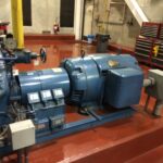 Industrial HVAC compressor and coil manufacturing floor representing supply chain financial risk