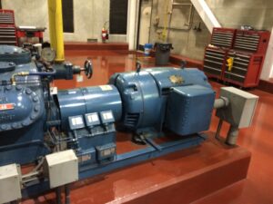 Industrial HVAC compressor and coil manufacturing floor representing supply chain financial risk