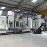 Industrial machinery factory floor with precision CNC equipment and metal components