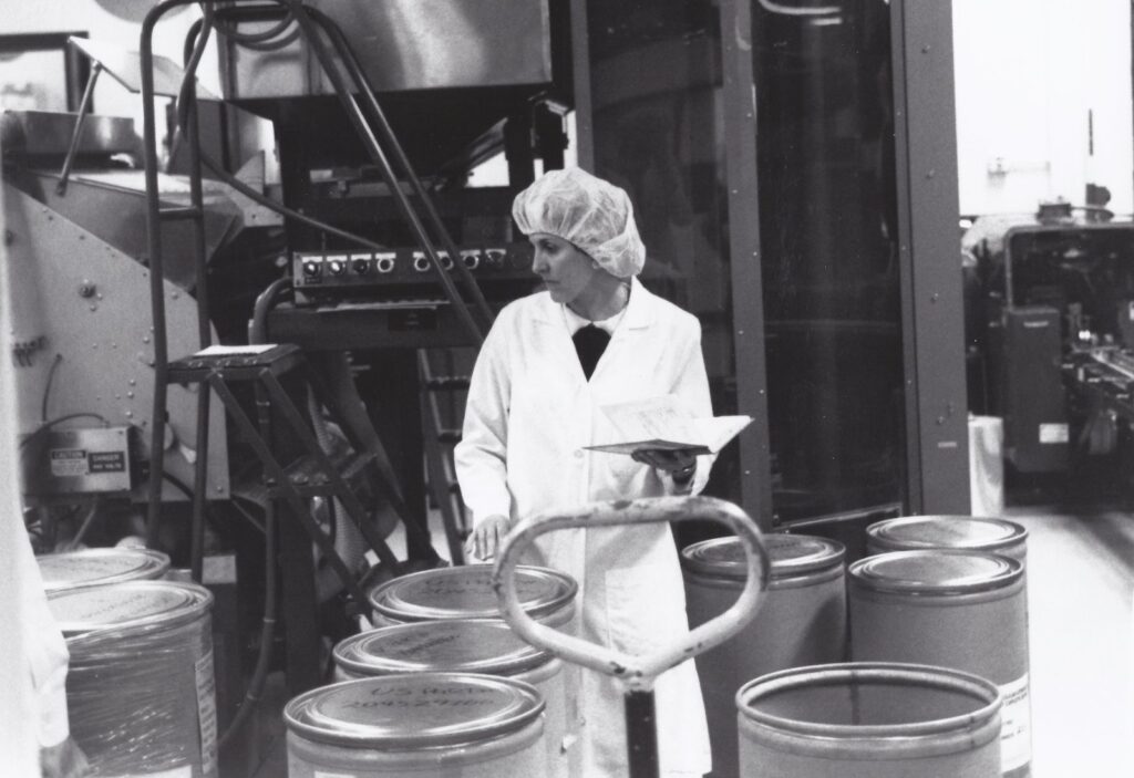 FDA quality control specialist examining bulk drug containers for active pharmaceutical ingredient sourcing compliance