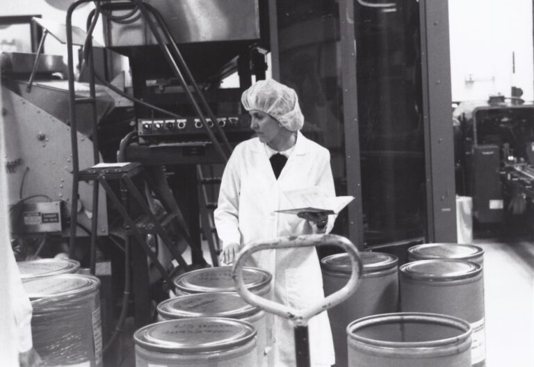 FDA quality control specialist examining bulk drug containers for active pharmaceutical ingredient sourcing compliance