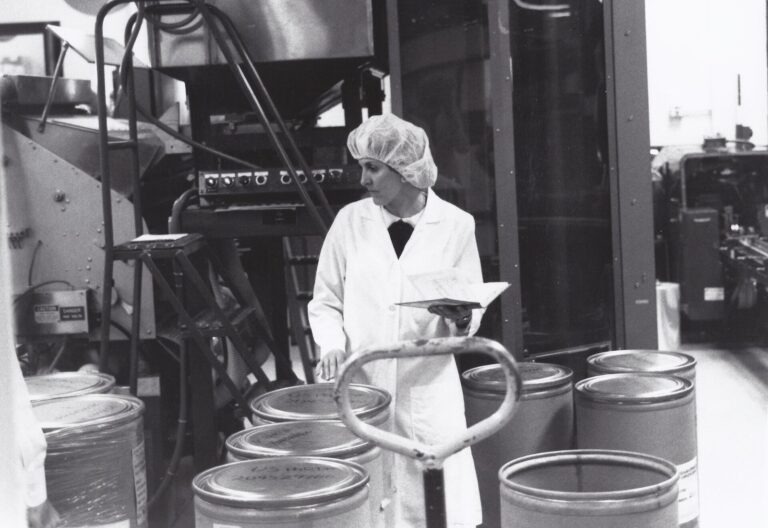 Pharmaceutical active ingredient manufacturing facility with stainless steel processing equipment, representing supplier financial risk monitoring