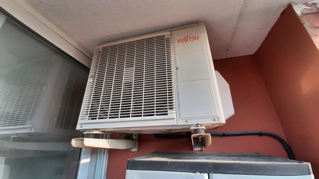 Industrial HVAC compressor and condenser units on a commercial building, representing supply chain risk in HVAC procurement