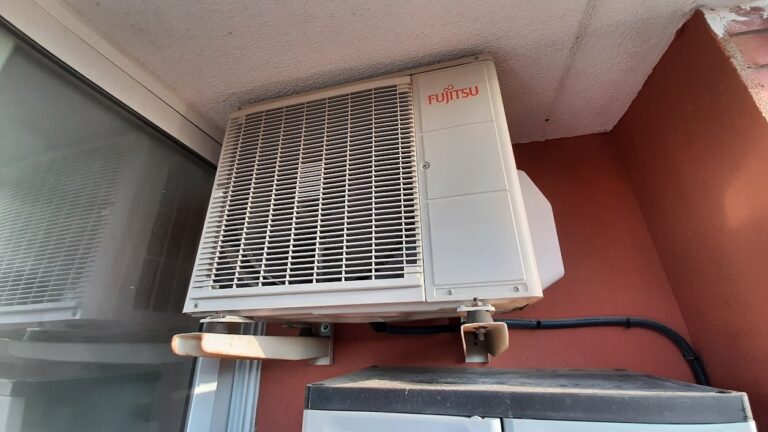 Industrial HVAC compressor and condenser units on a commercial building, representing supply chain risk in HVAC procurement