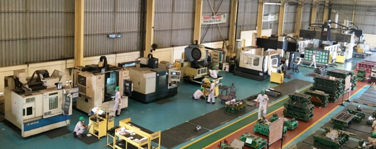Industrial machinery factory floor with steel components and precision CNC equipment