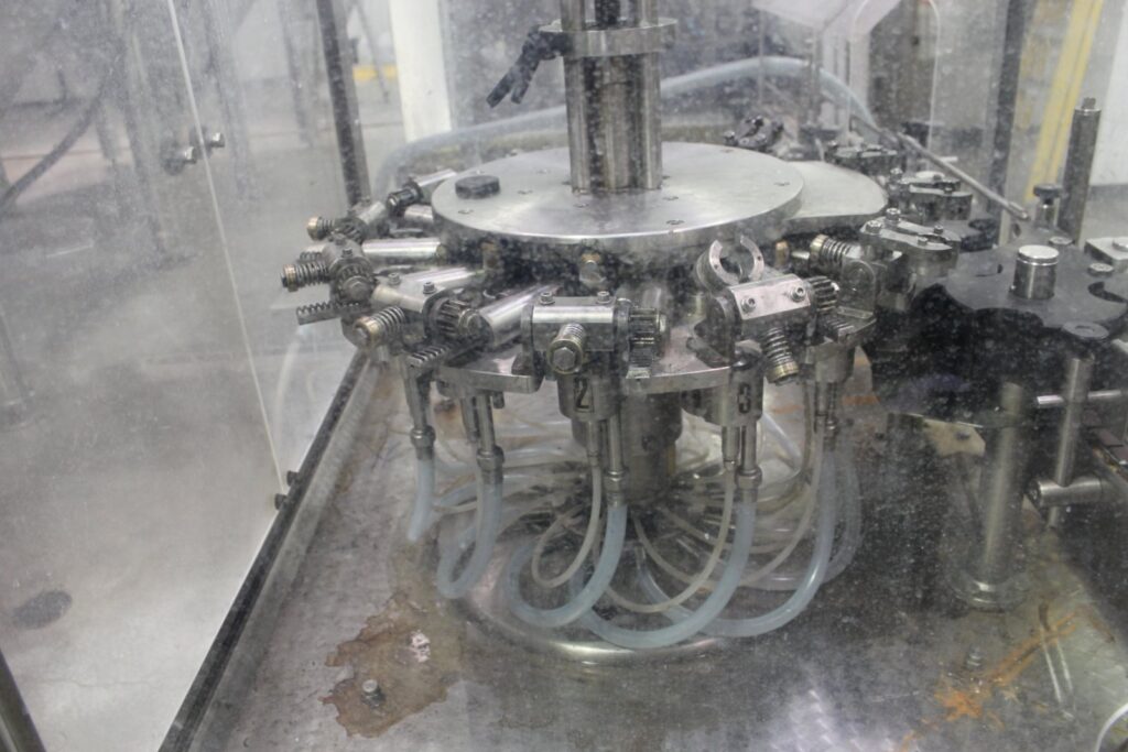 Consumer goods packaging and bottling line in a manufacturing facility