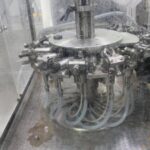 Consumer goods packaging and bottling line in a manufacturing facility