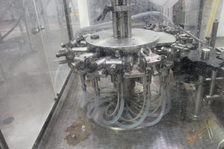 Consumer goods packaging and bottling line in a manufacturing facility