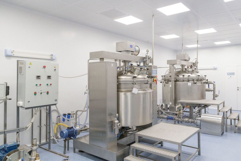 Stainless steel reactor vessels in a pharmaceutical manufacturing facility, illustrating how to monitor tier 2 suppliers of APIs and key starting materials