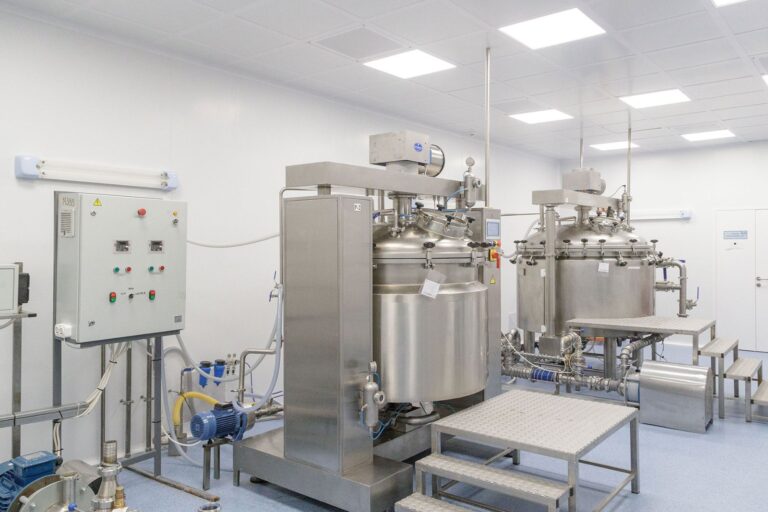 Stainless steel reactor vessels in a pharmaceutical manufacturing facility, illustrating how to monitor tier 2 suppliers of APIs and key starting materials