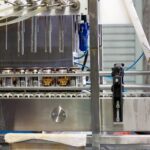 Beverage canning line filling aluminum cans, illustrating supply chain tariff impact on food and beverage packaging procurement