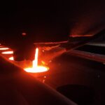 Molten cast iron poured into a sand mold at a metal foundry, illustrating signs a supplier is in financial trouble in industrial machinery sourcing