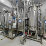 Stainless steel bioreactor and filtration skid in a pharmaceutical production plant, illustrating geographic concentration supply chain risk in API sourcing
