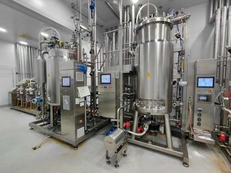 Stainless steel bioreactor and filtration skid in a pharmaceutical production plant, illustrating geographic concentration supply chain risk in API sourcing