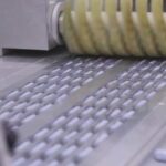 Tablets moving along a pharmaceutical production line, illustrating API supplier qualification risk and drug shortage exposure
